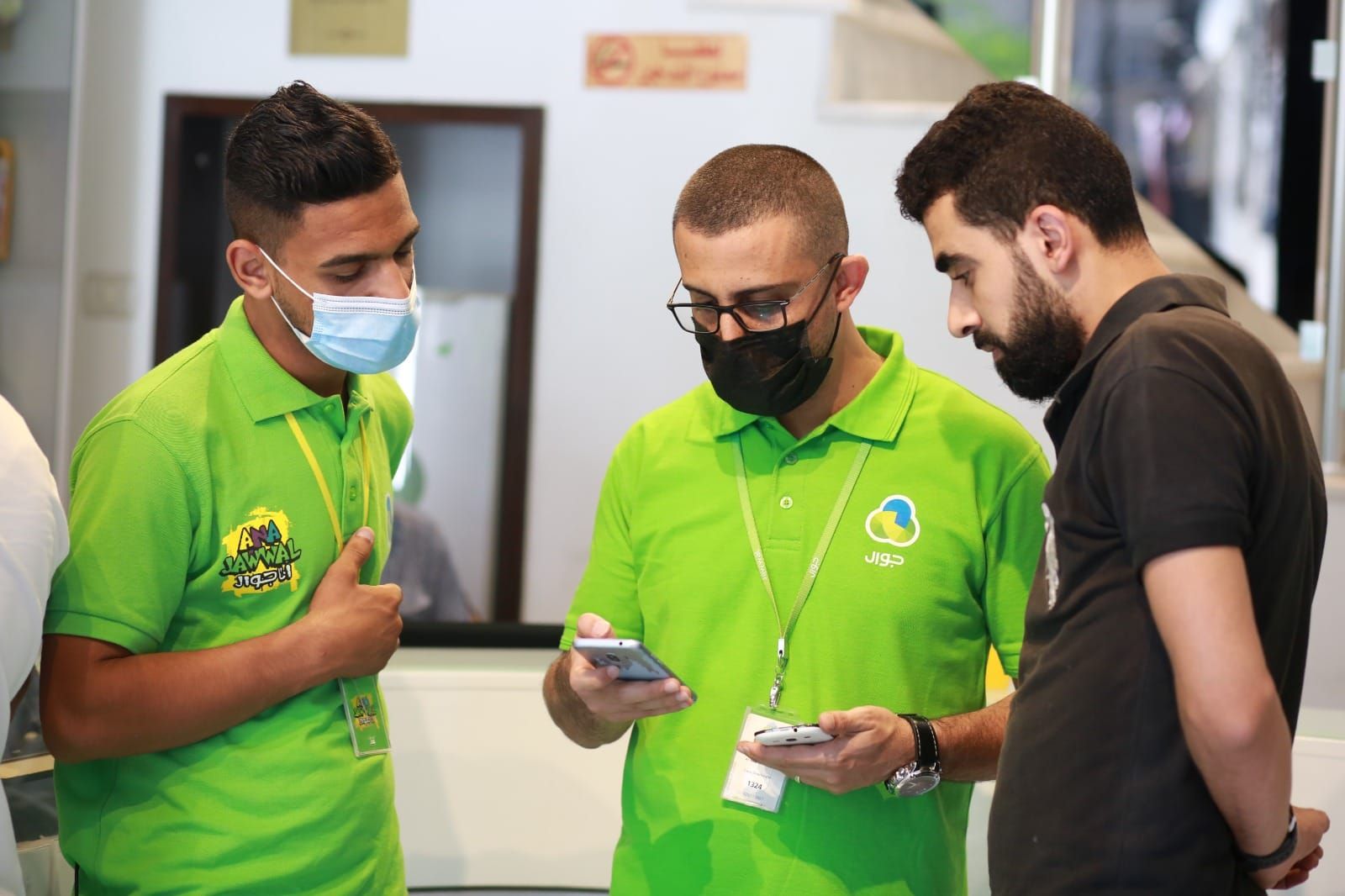 On the ground with an Ana Jawwal ambassador, helping a customer during an activation