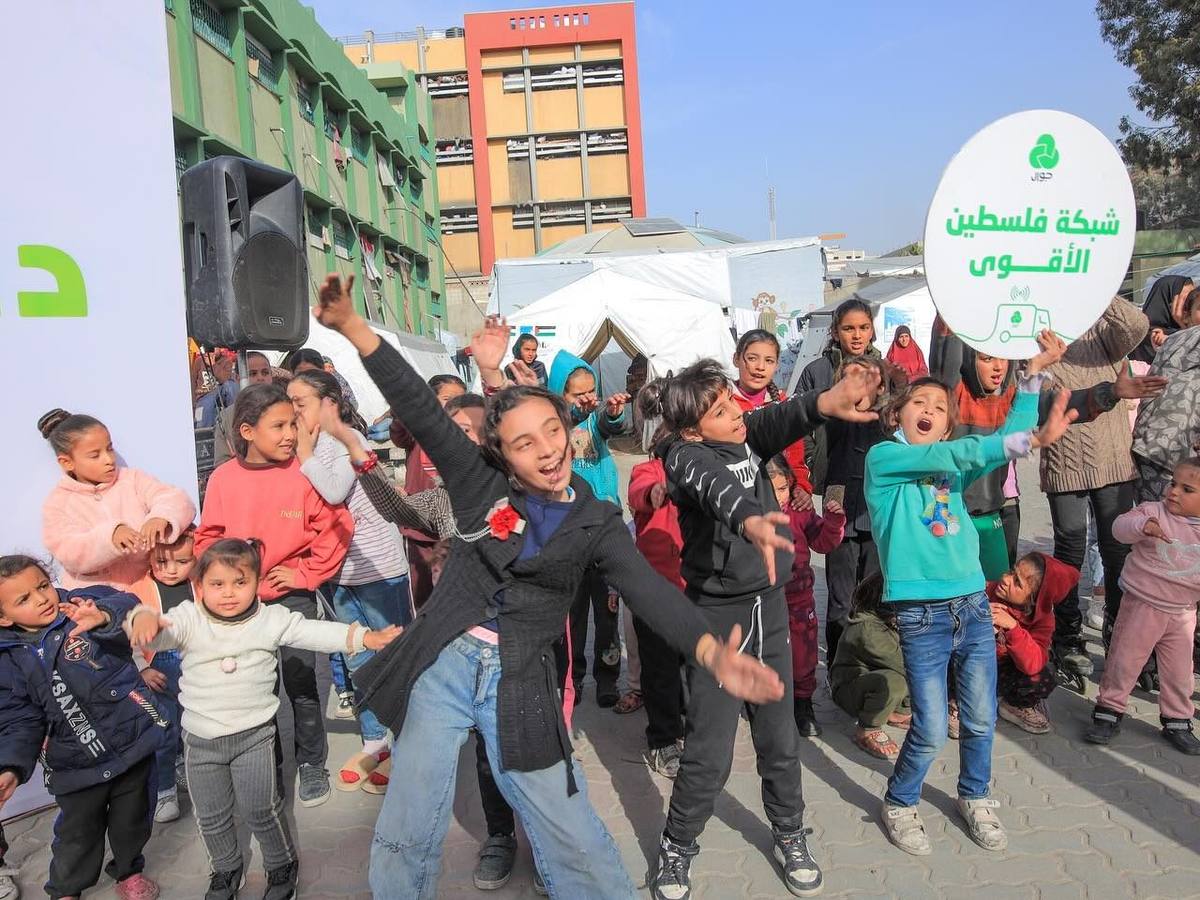 Children dancing at a Jawwal event in a displacement camp in Gaza